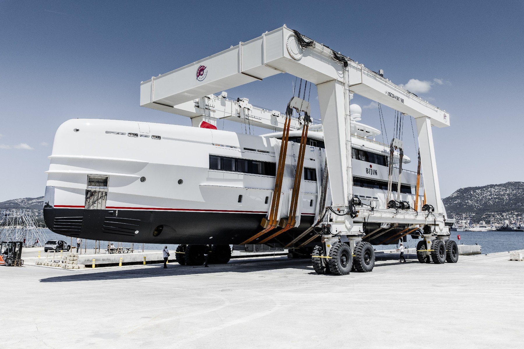 Yacht on travel lift at shipyard during refit
